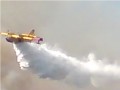 Canadair plane dropping water on a forest fire