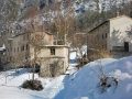 Patocco Chiusaforte casa montagna con la neve nel borgo sotto